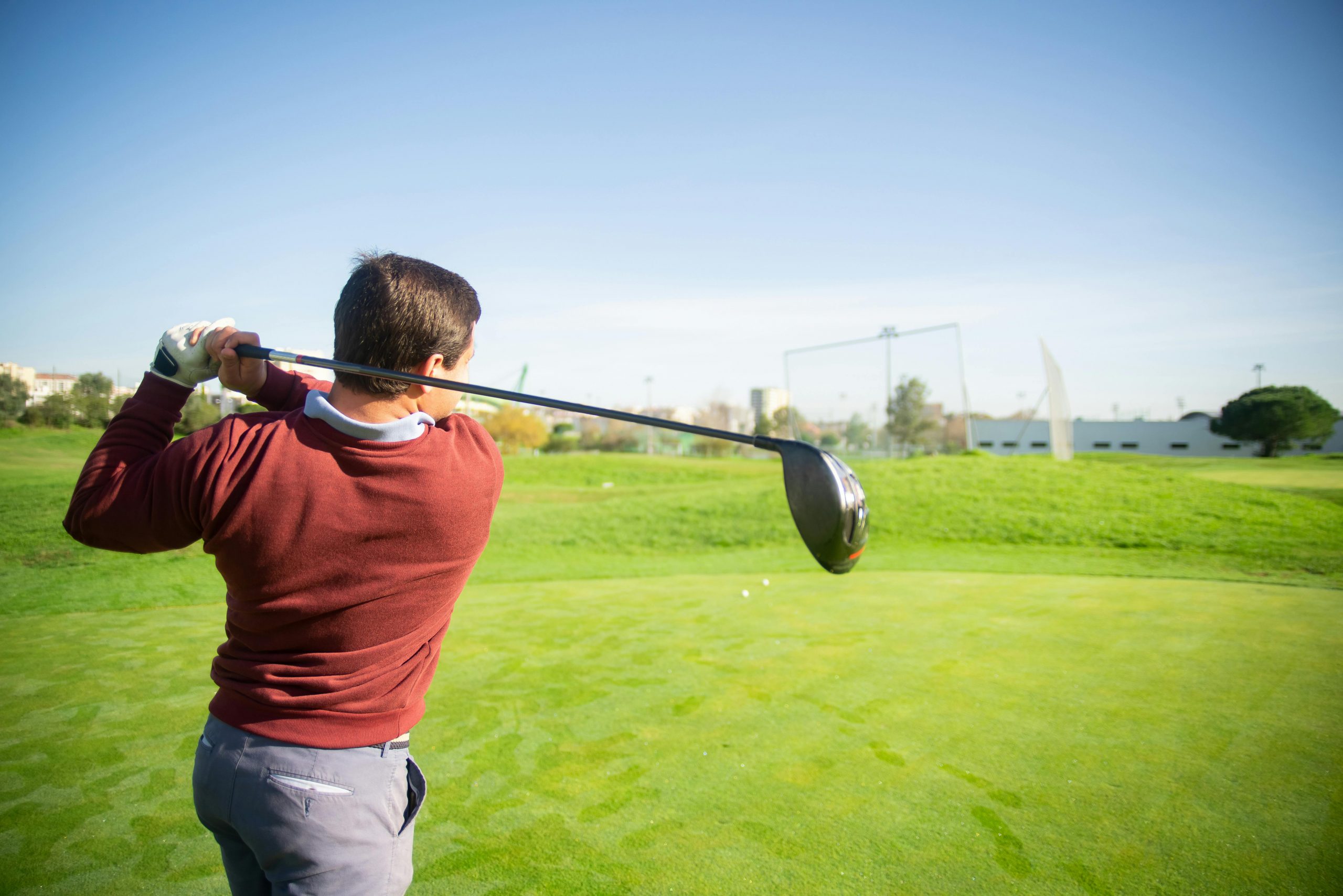 Golfer teeing off golf starter